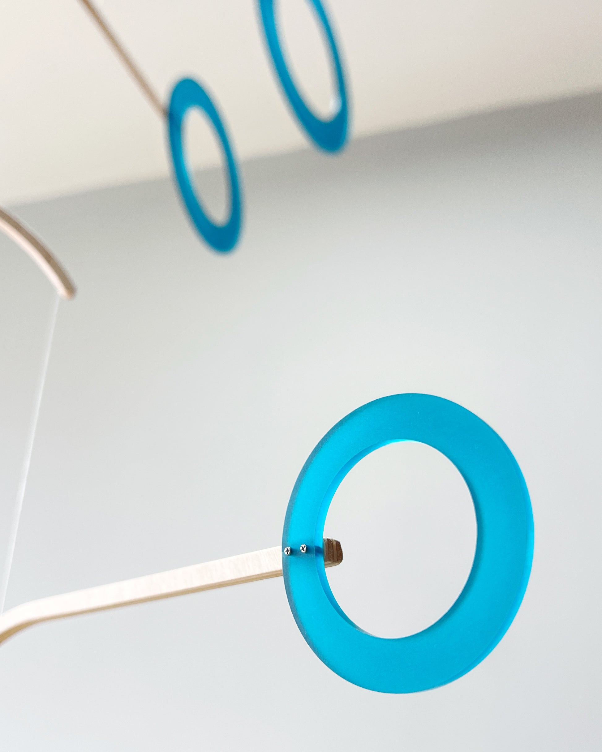 Teal Kinetic Hanging Mobile Sculpture, Minimalistic Circles Adult Mobile Home Decor - Halo Halo Handcrafted By The Illuminist
Introducing Halo Halo Mobile - A stunning piece of kinetic art that will bring movement and interest to any room. Handcrafted from responsibly sourced engineered birch, this unique mobile features six halo rings of increasing width and size in frosted Orange acrylic. Similar to my original Halo mobile but on a verticle plane.