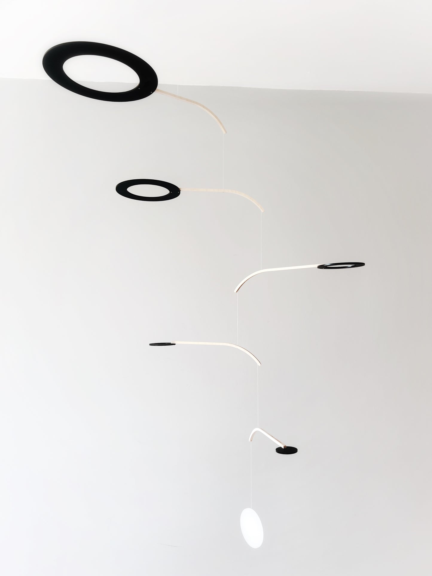 Large Kinetic Mobile Sculpture, Black Hanging Adult Mobile, Mid Century Modern Art Mobile, Calder Minimal Circle Mobile, Halo The Illuminist
Introducing Halo Mobile - A stunning piece of kinetic art that will bring movement and joy to any room. Handcrafted from responsibly sourced engineered birch, this unique mobile features six halo rings of increasing width and size in frosted black acrylic.