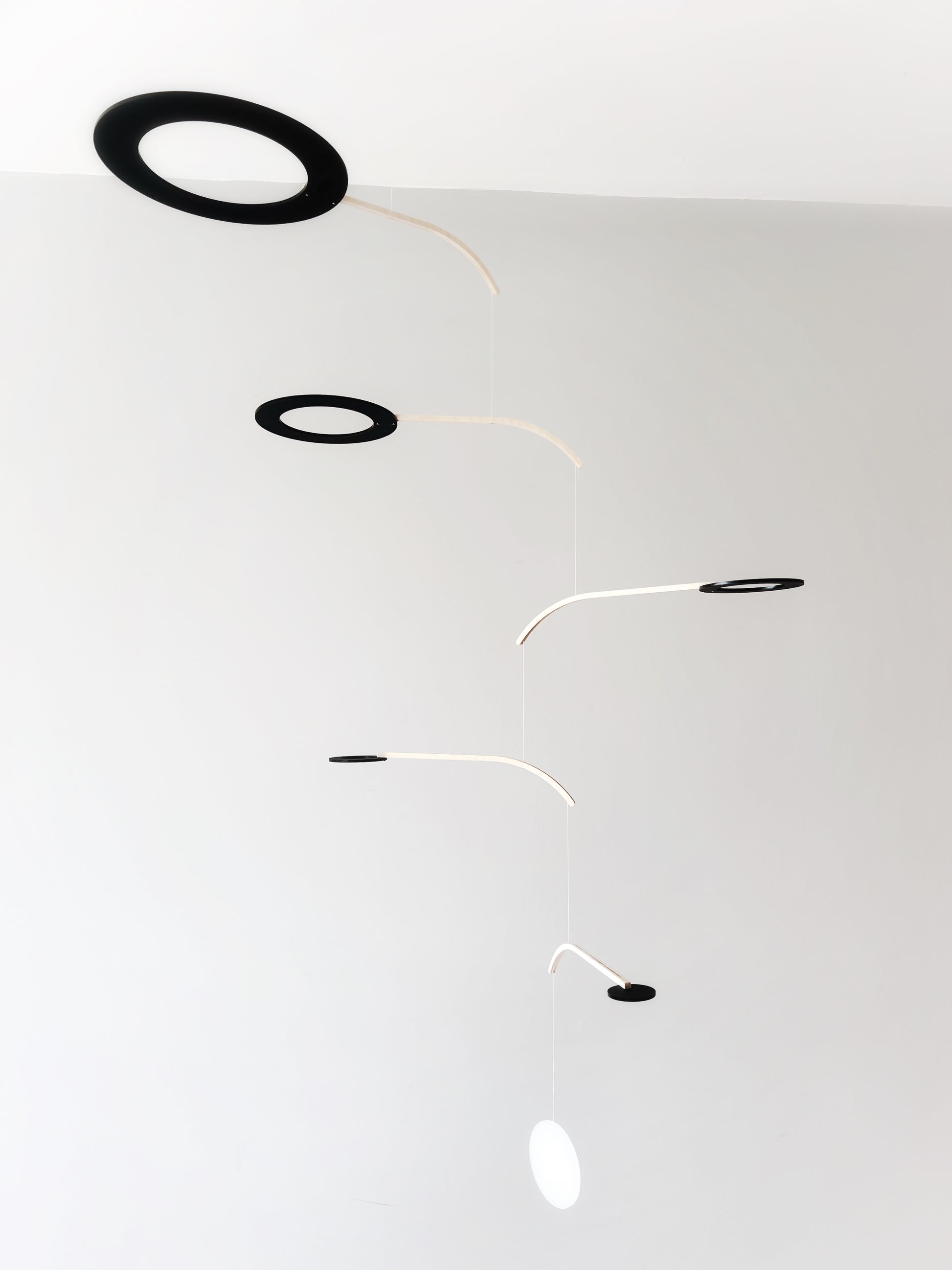 Large Kinetic Mobile Sculpture, Black Hanging Adult Mobile, Mid Century Modern Art Mobile, Calder Minimal Circle Mobile, Halo The Illuminist
Introducing Halo Mobile - A stunning piece of kinetic art that will bring movement and joy to any room. Handcrafted from responsibly sourced engineered birch, this unique mobile features six halo rings of increasing width and size in frosted black acrylic.