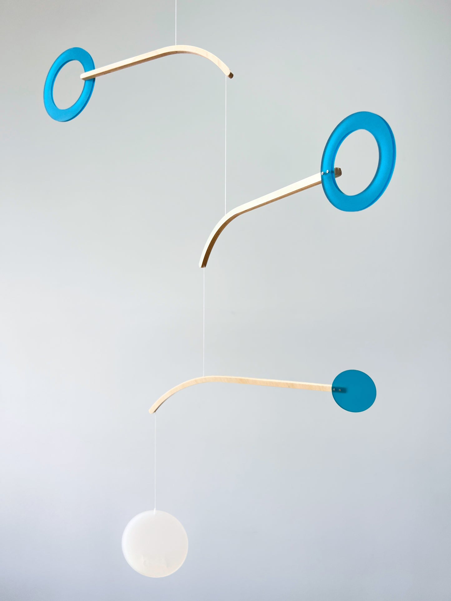 Teal Kinetic Hanging Mobile Sculpture, Minimalistic Circles Adult Mobile Home Decor - Halo Halo Handcrafted By The Illuminist
Introducing Halo Halo Mobile - A stunning piece of kinetic art that will bring movement and interest to any room. Handcrafted from responsibly sourced engineered birch, this unique mobile features six halo rings of increasing width and size in frosted Orange acrylic. Similar to my original Halo mobile but on a verticle plane.