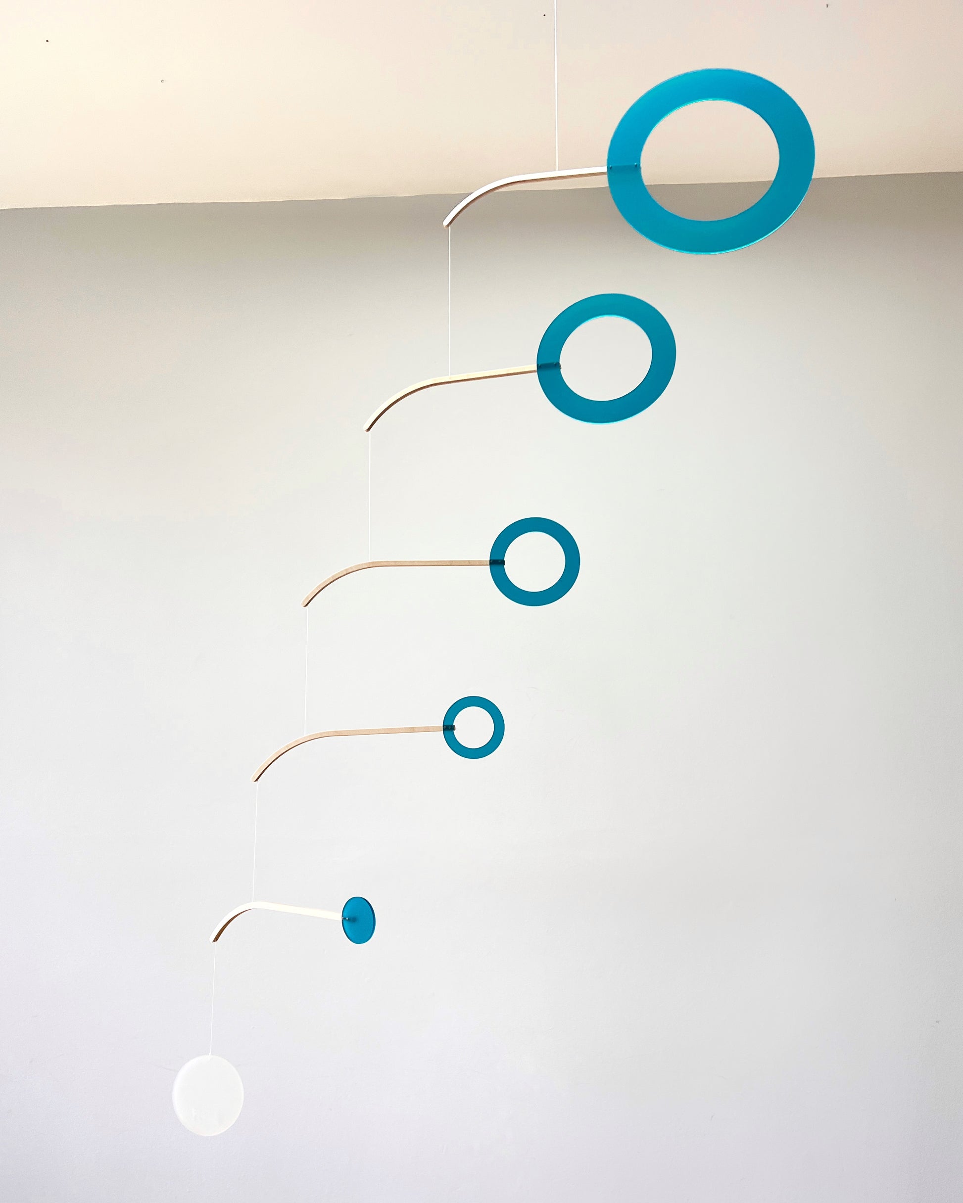 Teal Kinetic Hanging Mobile Sculpture, Minimalistic Circles Adult Mobile Home Decor - Halo Halo Handcrafted By The Illuminist
Introducing Halo Halo Mobile - A stunning piece of kinetic art that will bring movement and interest to any room. Handcrafted from responsibly sourced engineered birch, this unique mobile features six halo rings of increasing width and size in frosted Orange acrylic. Similar to my original Halo mobile but on a verticle plane.