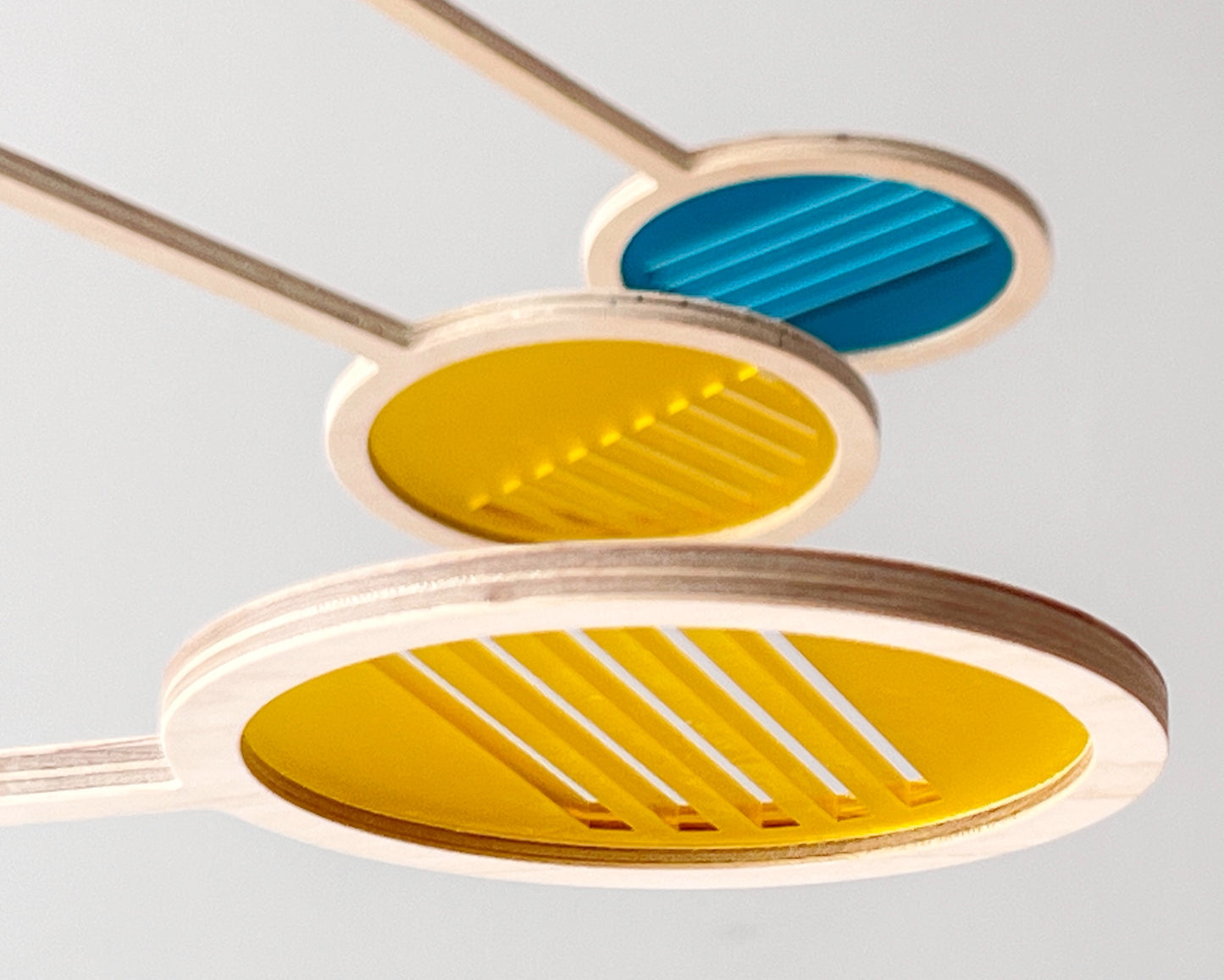 Custom Colour Geometric Kinetic Mobile Art, Adult & Baby Mobile. Line Pattern Relaxing Decor for Scandinavian Livingroom, Boho Nursey and Modern Office
A fresh take on my Orbit Mobile, with these stylish geometric stiped cut outs. adding a fresh dimention to it's mid-century design.
Made from birch wood and colourful acrylic mobile, Influenced by Calder mobiles and the mid-century modern movement. A beautiful piece of moving hanging art.