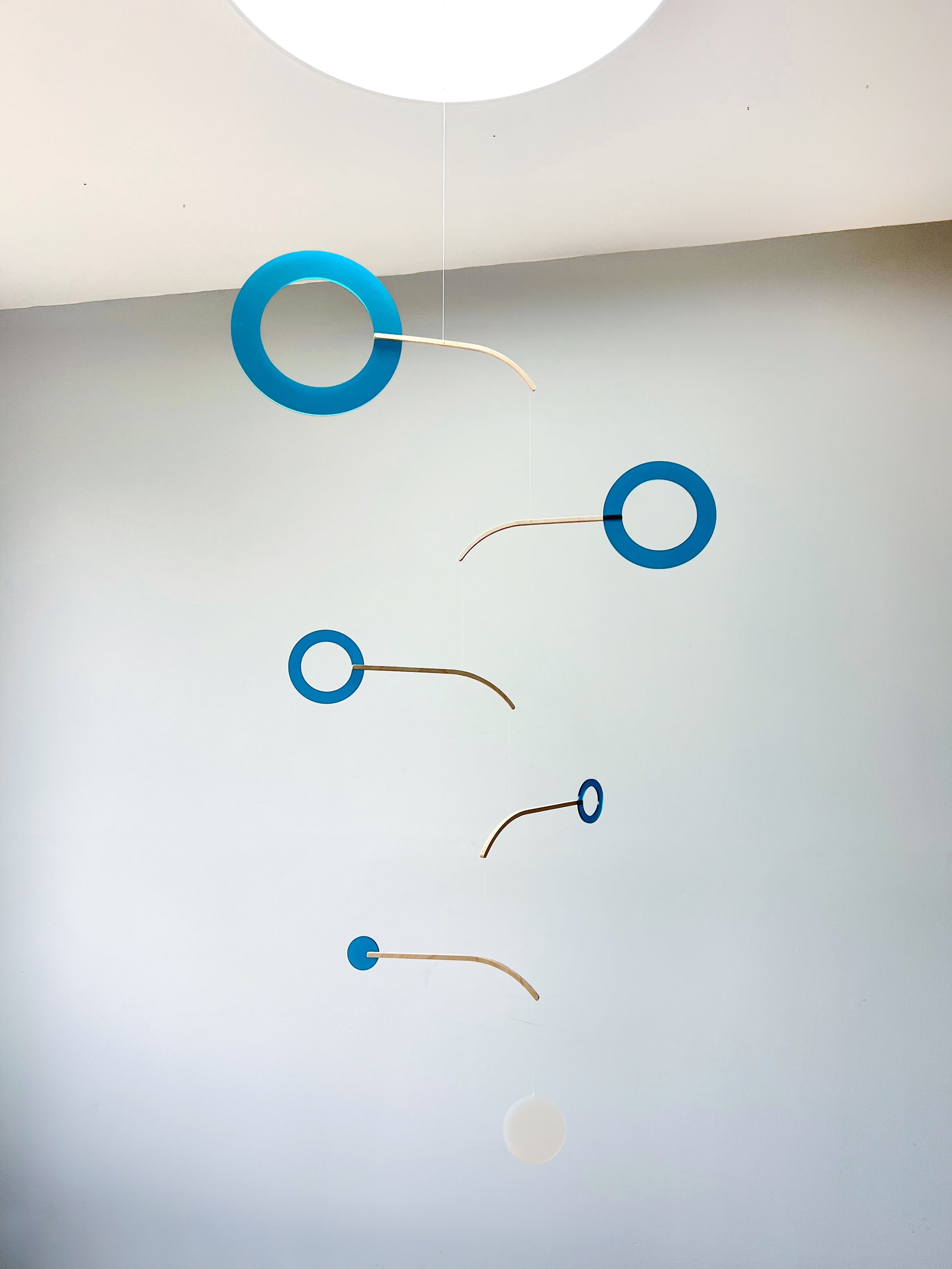 Teal Kinetic Hanging Mobile Sculpture, Minimalistic Circles Adult Mobile Home Decor - Halo Halo Handcrafted By The Illuminist
Introducing Halo Halo Mobile - A stunning piece of kinetic art that will bring movement and interest to any room. Handcrafted from responsibly sourced engineered birch, this unique mobile features six halo rings of increasing width and size in frosted Orange acrylic. Similar to my original Halo mobile but on a verticle plane.