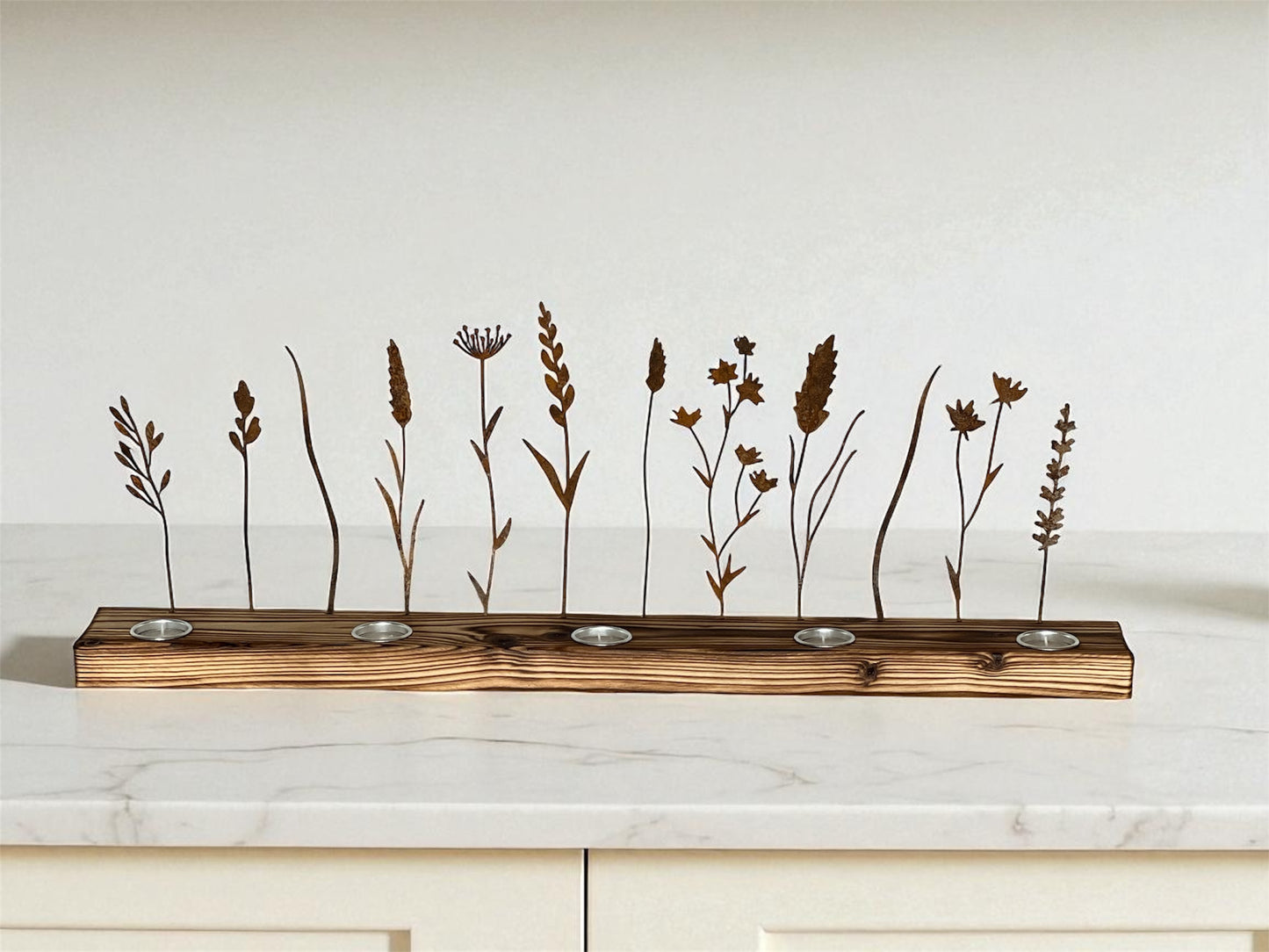 Metal wildflower silhouettes designed to create shadow art with flickering tea light candles