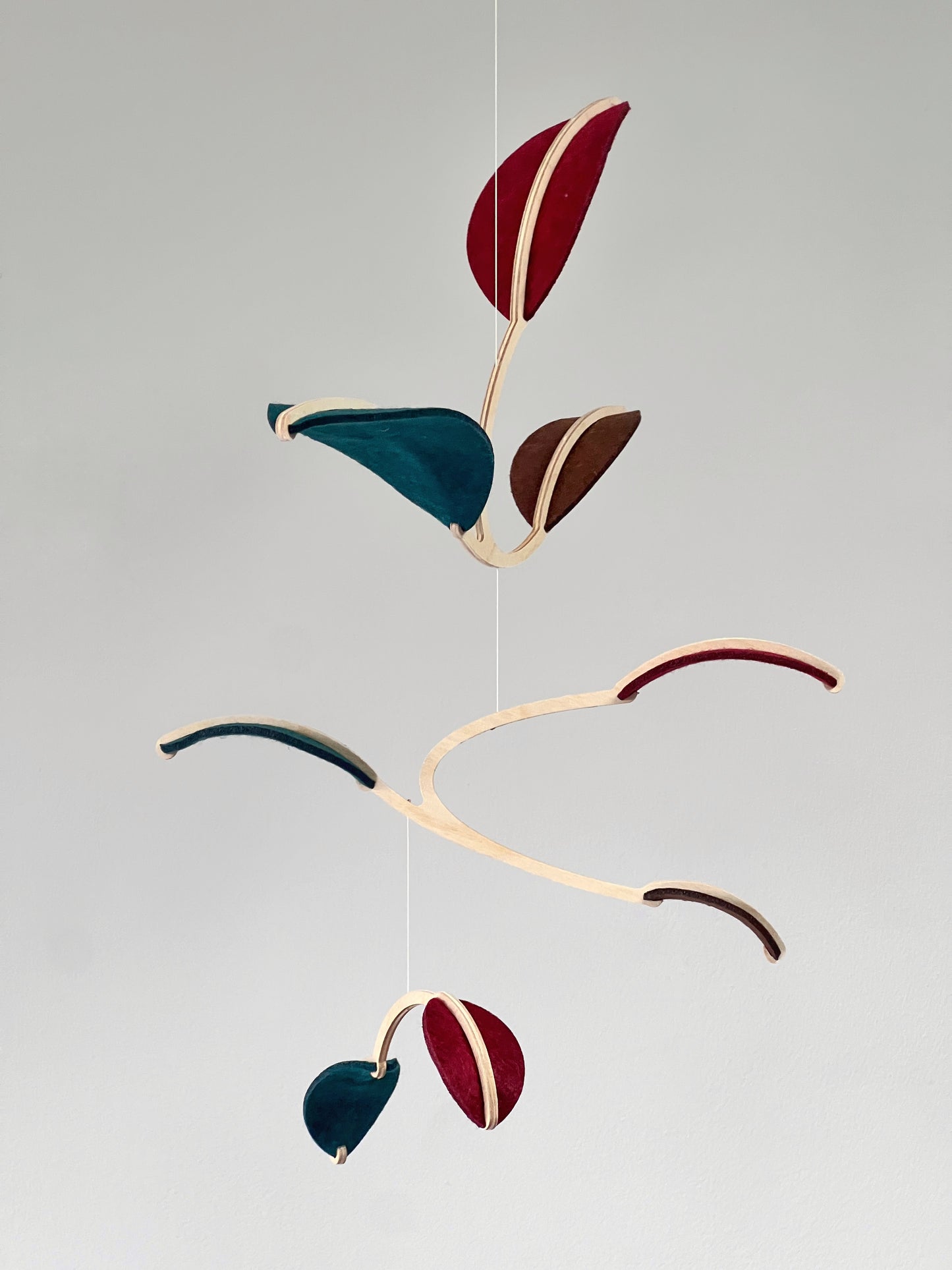 Felt & Wood Leaf Mobile, Adult or Baby Mobile Gift Idea, Plant inspired Sculpture, Kinetic Art Mobile. Maroon, Teal and Brown.
This vibrant felt leaf mobile is a charming addition to your home decor, offering a lightweight and artistic touch. Handmade with colorful felt leaf shapes, it features independently rotating wooden stems crafted from birch wood, arranged in a customizable color order that can be adjusted anytime.