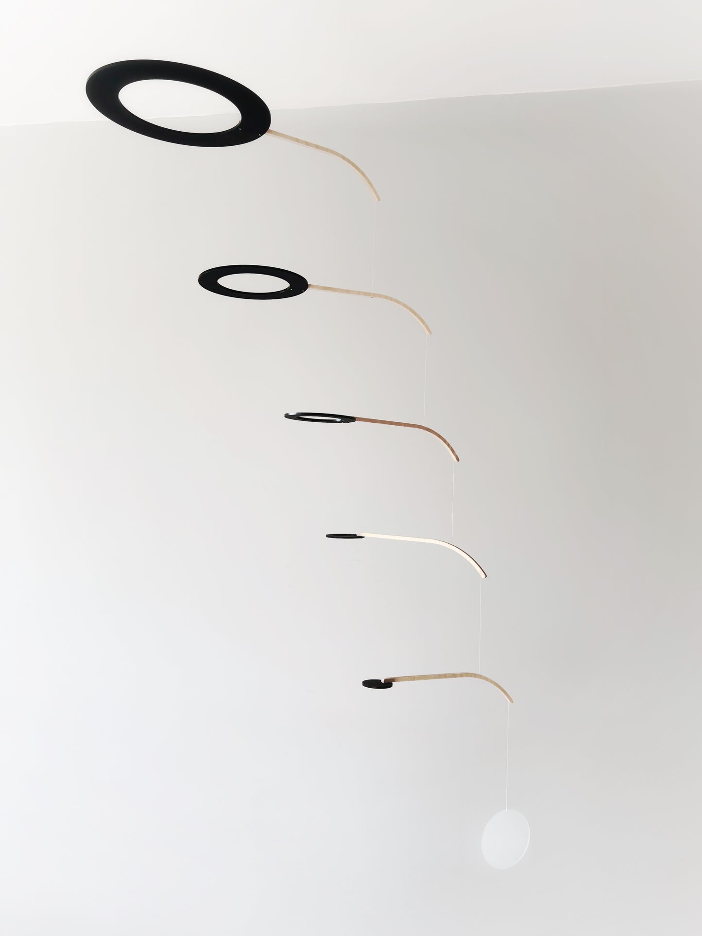 Large Kinetic Mobile Sculpture, Black Hanging Adult Mobile, Mid Century Modern Art Mobile, Calder Minimal Circle Mobile, Halo The Illuminist
Introducing Halo Mobile - A stunning piece of kinetic art that will bring movement and joy to any room. Handcrafted from responsibly sourced engineered birch, this unique mobile features six halo rings of increasing width and size in frosted black acrylic.