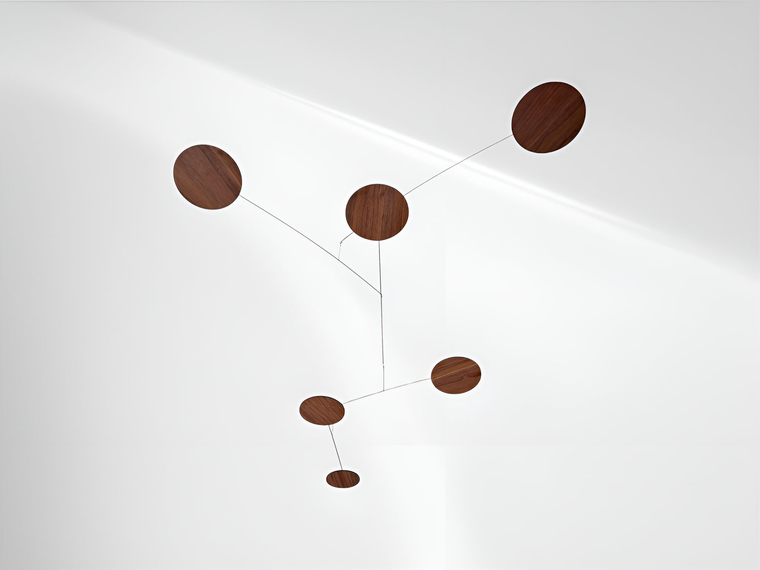 A handcrafted wooden mobile — a modern mobile, inspired by Alexander Calders’ mobile kinetic sculptures for mid century decor lovers. This elegant hanging mobile is a piece of moving art and a mobile for adults, bringing calm motion, balance, and timeless design to your home.
This mid century mobile is a beautifully balanced kinetic mobile, art mobile, and large mobile that drifts gracefully with the air. Handcrafted from fine walnut veneer and stainless steel wire, it combines organic warmth with minimal