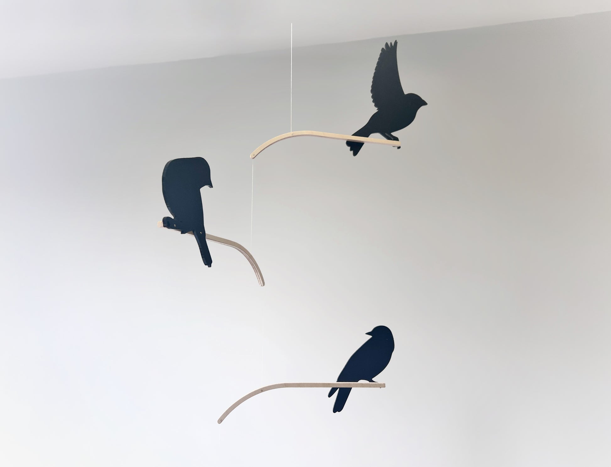 Nosey Bird Kinetic Mobile Sculpture, Adult & Baby Mobile. Hanging Silhouette Wall Art, Counterbalanced Handcrafted Acrylic & Wood Bird Mobile

Introducing ‘Nosey Birds’ - A fun piece of kinetic art that will bring movement and interest to any room. Handcrafted from responsibly sourced engineered birch, this unique mobile features 5 laser cut bird silhouettes of increasing size in a stunning frosted black acrylic. Composed so the birds are looking towards each other while perched on the curved birch arm.