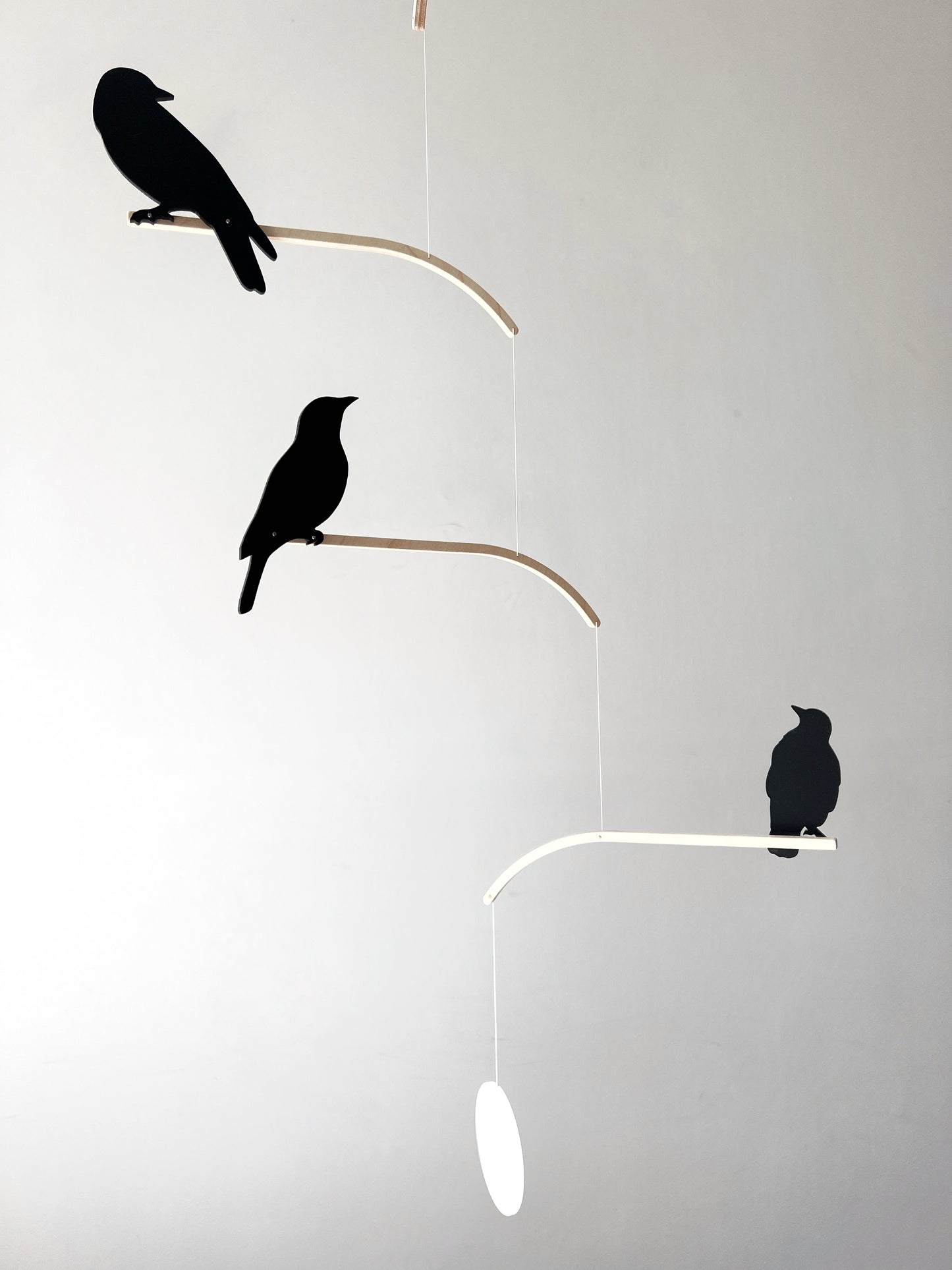 Nosey Bird Kinetic Mobile Sculpture, Adult & Baby Mobile. Hanging Silhouette Wall Art, Counterbalanced Handcrafted Acrylic & Wood Bird Mobile

Introducing ‘Nosey Birds’ - A fun piece of kinetic art that will bring movement and interest to any room. Handcrafted from responsibly sourced engineered birch, this unique mobile features 5 laser cut bird silhouettes of increasing size in a stunning frosted black acrylic. Composed so the birds are looking towards each other while perched on the curved birch arm.