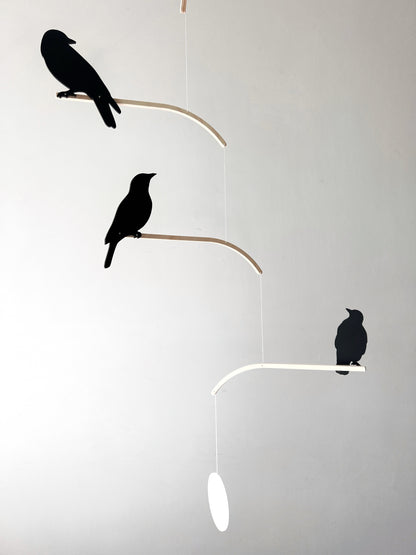 Nosey Bird Kinetic Mobile Sculpture, Adult & Baby Mobile. Hanging Silhouette Wall Art, Counterbalanced Handcrafted Acrylic & Wood Bird Mobile

Introducing ‘Nosey Birds’ - A fun piece of kinetic art that will bring movement and interest to any room. Handcrafted from responsibly sourced engineered birch, this unique mobile features 5 laser cut bird silhouettes of increasing size in a stunning frosted black acrylic. Composed so the birds are looking towards each other while perched on the curved birch arm.