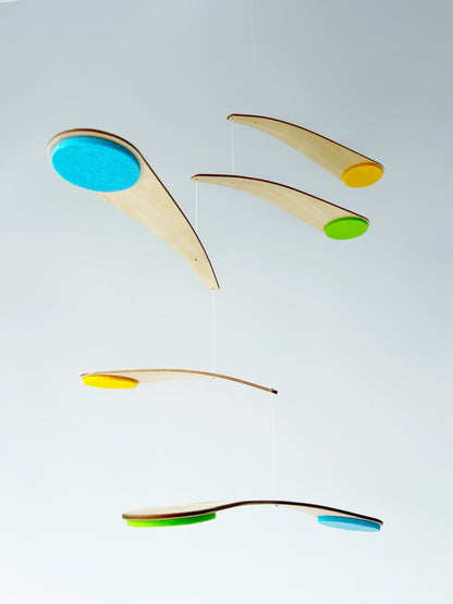 The Bo Mobile is a modern handmade Nursery mobile designed to be viewed from below — just as your baby experiences it from their crib. Lightweight curved wooden arms are carefully counterbalanced so the mobile appears to float effortlessly in the air, creating a calm and captivating visual experience.

