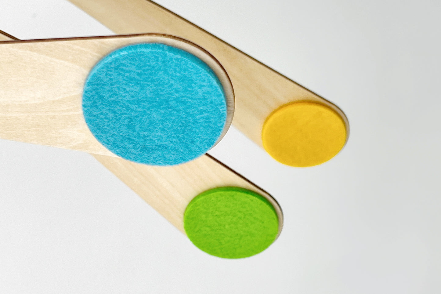 Montessori Crib Mobile, Hanging Baby Mobile with Floating Walnut Arms & Spinning Felt Circles
Colorful wooden mobile with blue, yellow, and green felt circles on a white background