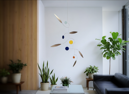 Inspired by Calder mobiles this is a modern Modern living room with a colorful abstract sculpture on a white wall, plants, and a black sofa. Rise MOBILE - Mid century Kinetic mobile sculpture 